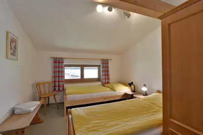 Ein Bett oder Betten in einem Zimmer der Unterkunft APARTMENTS Pension Foidl