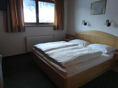 Ein Bett oder Betten in einem Zimmer der Unterkunft Hotel Garni Klocker