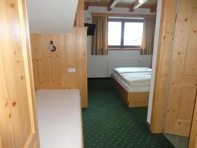 Ein Bett oder Betten in einem Zimmer der Unterkunft Hotel Garni Klocker
