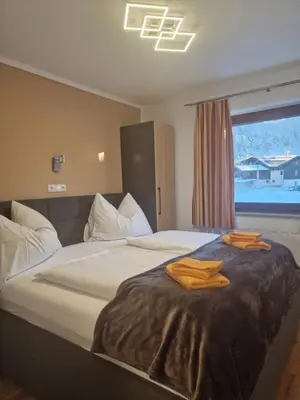 Ein Bett oder Betten in einem Zimmer der Unterkunft Appartementhaus Hüttenberger