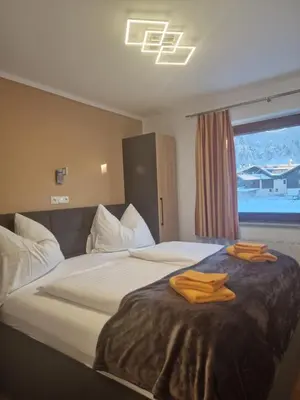 Ein Bett oder Betten in einem Zimmer der Unterkunft Appartementhaus Hüttenberger