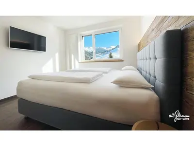 Ein Bett oder Betten in einem Zimmer der Unterkunft All.Glemm SKY SUITE