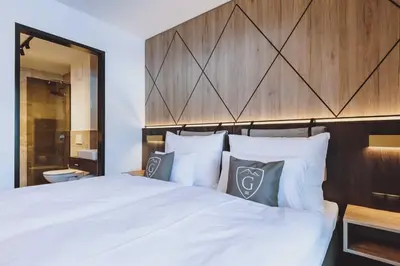 Ein Bett oder Betten in einem Zimmer der Unterkunft GLEMM by AvenidA Superior Hotel & Residences