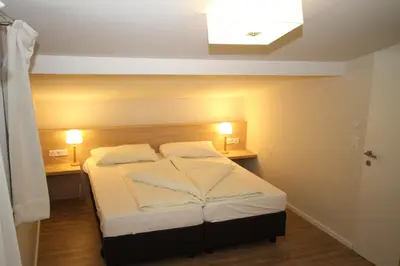 Ein Bett oder Betten in einem Zimmer der Unterkunft Hoss
