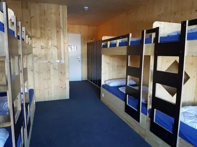Ein Bett oder Betten in einem Zimmer der Unterkunft Jugendgästehaus Gerlosplatte