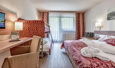 Ein Bett oder Betten in einem Zimmer der Unterkunft Familienhotel Christoph