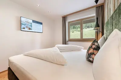 Ein Bett oder Betten in einem Zimmer der Unterkunft Hotel AlpenSchlössl
