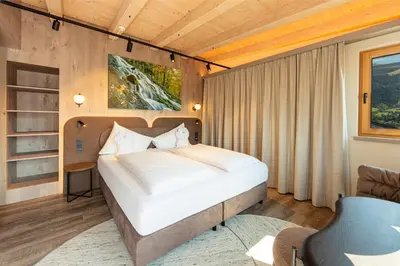 Ein Bett oder Betten in einem Zimmer der Unterkunft Aktivhotel Schweizerhof Kitzbühel