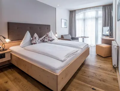 Ein Bett oder Betten in einem Zimmer der Unterkunft Aktivhotel Schweizerhof Kitzbühel