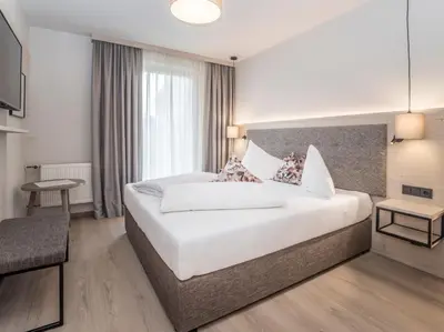 Ein Bett oder Betten in einem Zimmer der Unterkunft Aktivhotel Schweizerhof Kitzbühel