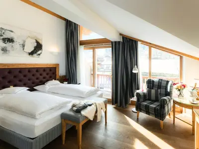 Ein Bett oder Betten in einem Zimmer der Unterkunft Hotel Kaiserhof Kitzbühel, 4 Sterne Superior