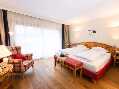 Ein Bett oder Betten in einem Zimmer der Unterkunft Hotel Kaiserhof Kitzbühel, 4 Sterne Superior