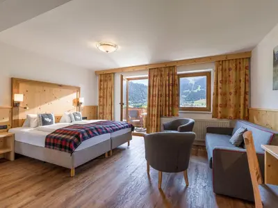 Ein Bett oder Betten in einem Zimmer der Unterkunft Hotel Alpenpanorama