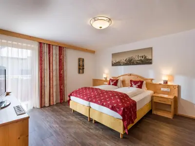 Ein Bett oder Betten in einem Zimmer der Unterkunft Hotel Alpenpanorama