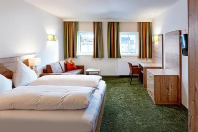 Ein Bett oder Betten in einem Zimmer der Unterkunft Hotel Flatscher