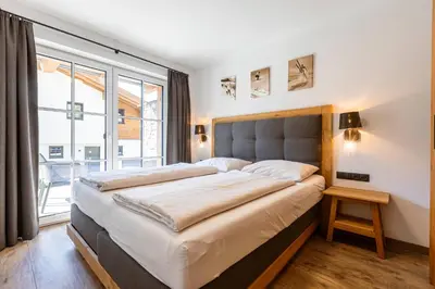 Ein Bett oder Betten in einem Zimmer der Unterkunft Tauernlodges Uttendorf by ALPS RESORTS