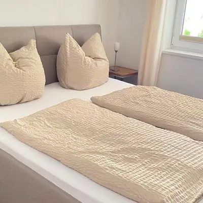 Ein Bett oder Betten in einem Zimmer der Unterkunft Buchensteinblick