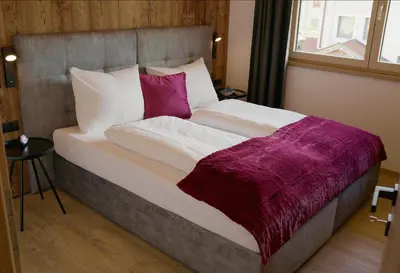 Ein Bett oder Betten in einem Zimmer der Unterkunft Alpen Quartier
