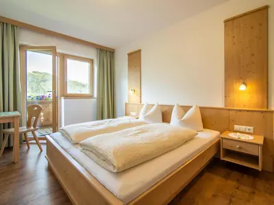 Ein Bett oder Betten in einem Zimmer der Unterkunft Blasinghof I