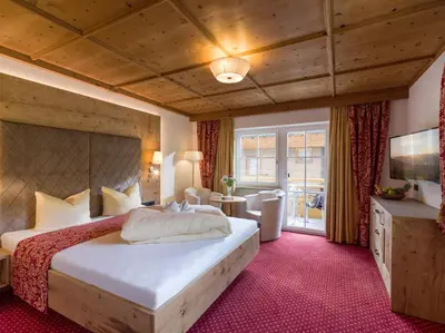 Ein Bett oder Betten in einem Zimmer der Unterkunft Alpenherz Hotel Garni