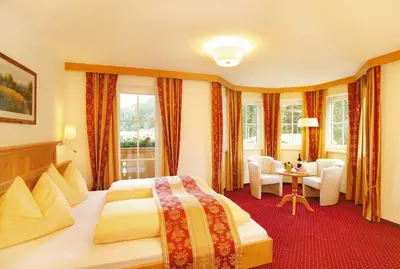 Ein Bett oder Betten in einem Zimmer der Unterkunft Alpenherz Hotel Garni