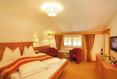 Ein Bett oder Betten in einem Zimmer der Unterkunft Alpenherz Hotel Garni