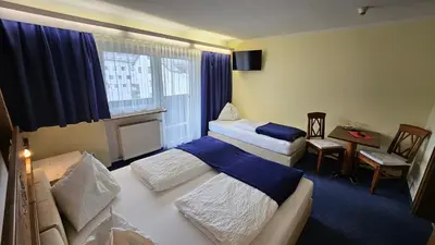 Ein Bett oder Betten in einem Zimmer der Unterkunft Panoramahotel