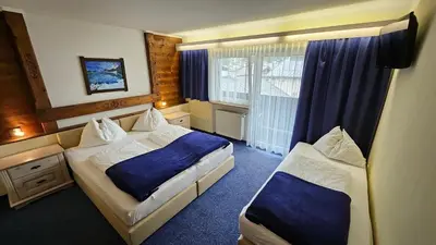 Ein Bett oder Betten in einem Zimmer der Unterkunft Panoramahotel