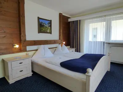 Ein Bett oder Betten in einem Zimmer der Unterkunft Panoramahotel