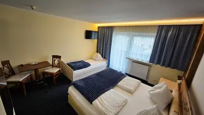 Ein Bett oder Betten in einem Zimmer der Unterkunft Panoramahotel