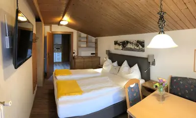 Ein Bett oder Betten in einem Zimmer der Unterkunft otto steiner appartements pension ellmau & wilder kaiser