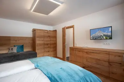 Ein Bett oder Betten in einem Zimmer der Unterkunft otto steiner appartements pension ellmau & wilder kaiser
