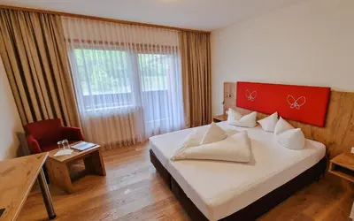 Ein Bett oder Betten in einem Zimmer der Unterkunft Das Alpin - Hotel Garni Guesthouse