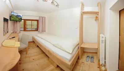 Ein Bett oder Betten in einem Zimmer der Unterkunft Riederhof