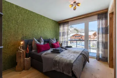 Ein Bett oder Betten in einem Zimmer der Unterkunft Panoramasuite Brixental - Brixen im Thale