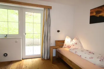 Ein Bett oder Betten in einem Zimmer der Unterkunft Ferienhaus zur Kundler Klamm WILD012
