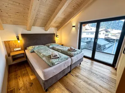 Ein Bett oder Betten in einem Zimmer der Unterkunft Our's Living Penthouse - private Sauna - near Kitzbüheler Alpen ski lift