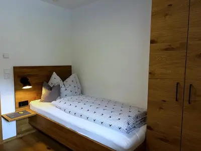 Ein Bett oder Betten in einem Zimmer der Unterkunft Ferienwohnungen Kirchenwirt