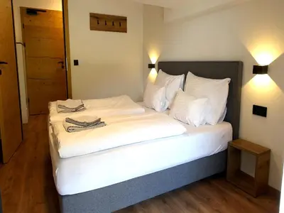 Ein Bett oder Betten in einem Zimmer der Unterkunft Bergzeit flat Saalbach directly on the ski piste
