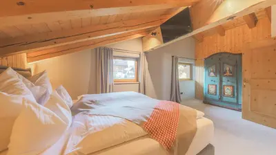 Ein Bett oder Betten in einem Zimmer der Unterkunft Chalet Lindau Fieberbrunn - by ONE VILLAS