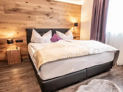 Ein Bett oder Betten in einem Zimmer der Unterkunft ApartKlusiv Kaltenbach