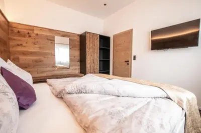 Ein Bett oder Betten in einem Zimmer der Unterkunft ApartKlusiv Kaltenbach