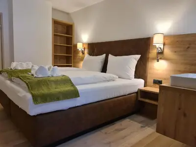 Ein Bett oder Betten in einem Zimmer der Unterkunft Hotel Alpenhof***