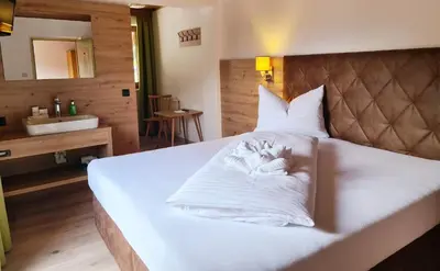 Ein Bett oder Betten in einem Zimmer der Unterkunft Hotel Alpenhof***