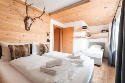 Ein Bett oder Betten in einem Zimmer der Unterkunft Westendorf Alpen Lodge