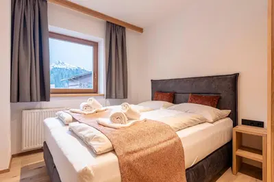 Ein Bett oder Betten in einem Zimmer der Unterkunft Dorfresort Kitzbühel by ALPS RESORTS