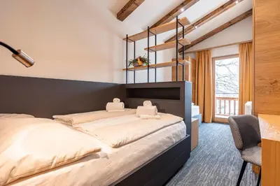 Ein Bett oder Betten in einem Zimmer der Unterkunft Dorfresort Kitzbühel by ALPS RESORTS