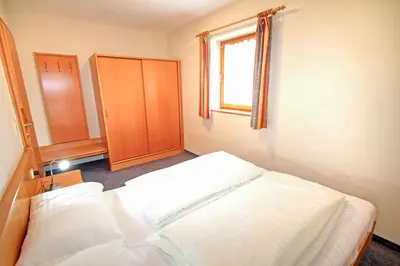 Ein Bett oder Betten in einem Zimmer der Unterkunft Ferienwohnung Königsleiten 2a - Top UG
